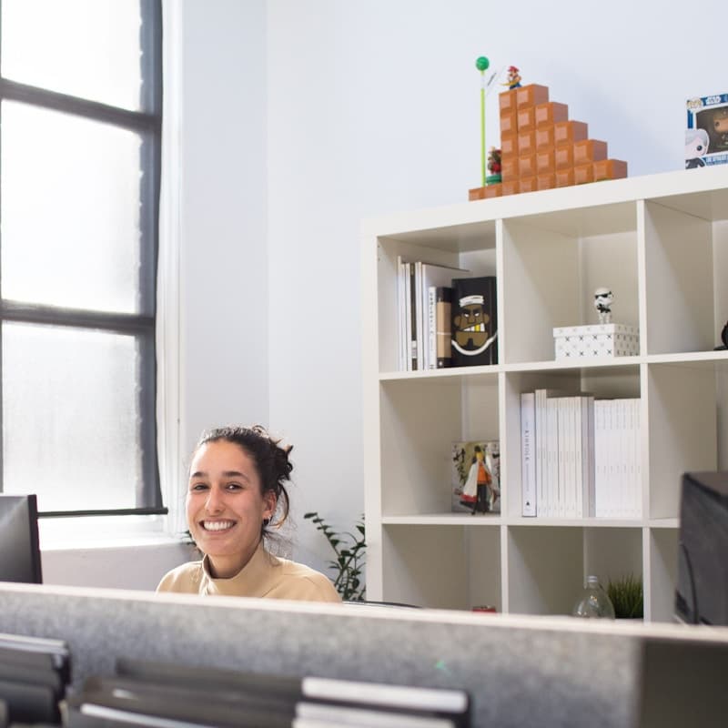 Care worker at a desk smiling